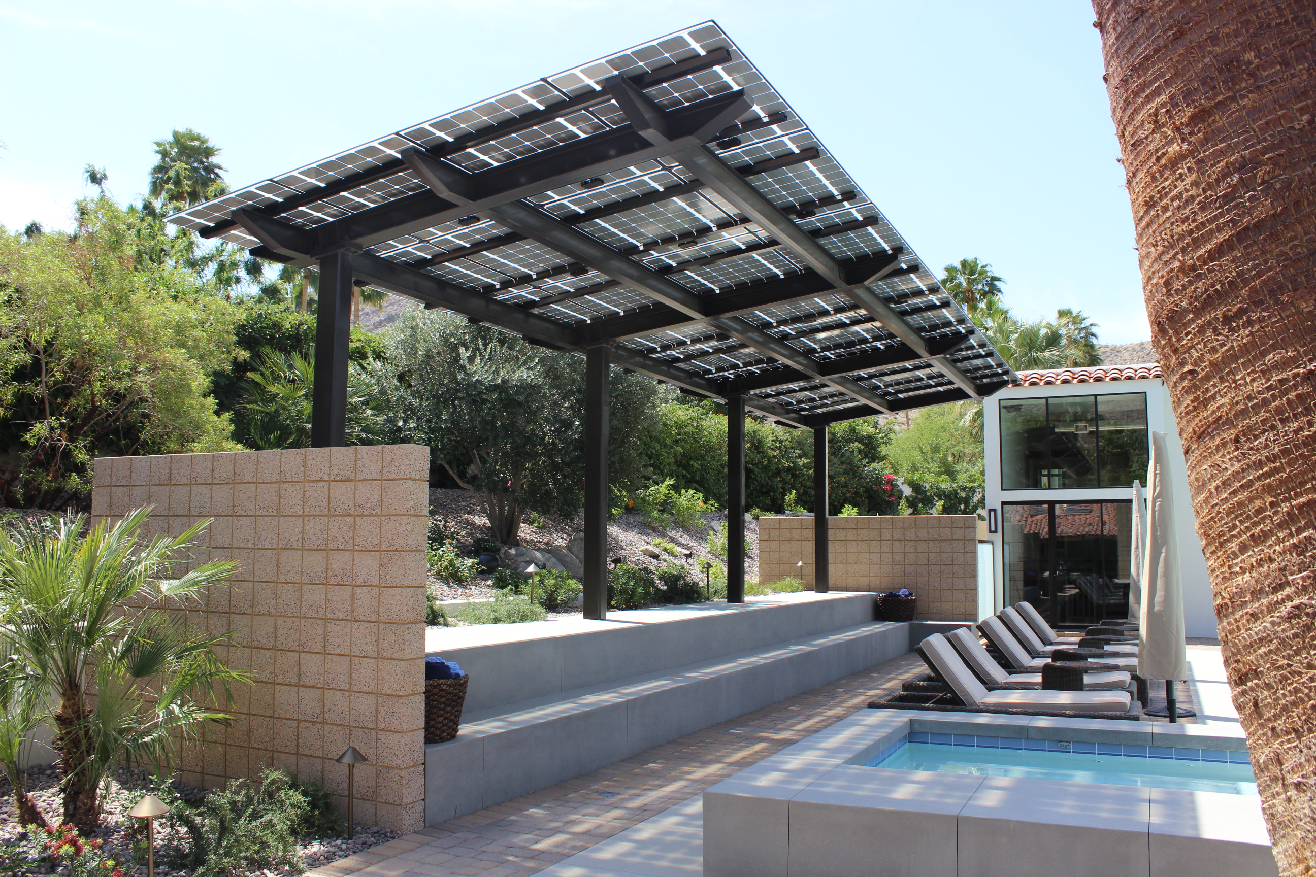 LSX Module Solar Patio Cover provides shade and solar power for this backyard swimming pool with the hills of Palm Springs in the background. Winner of Architectural Products PIA 2016 Award