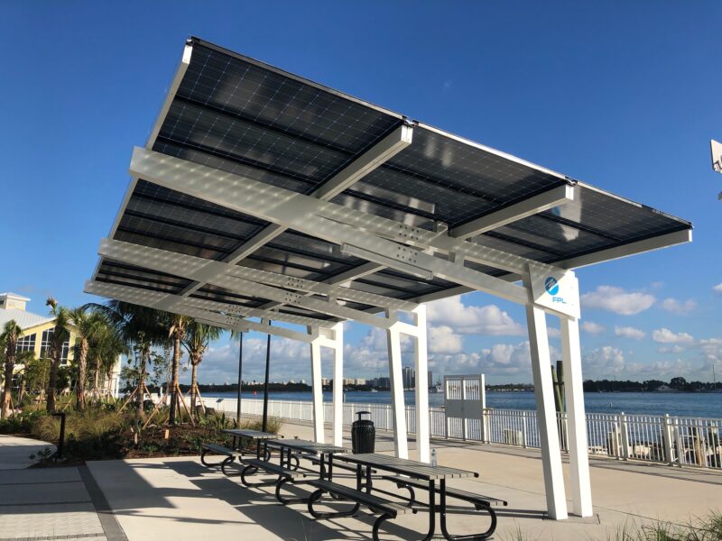 Solar Canopy Shade Structure provides shade and solar power for people at the picnic area in front of the water at the Manatee Viewing Center in Florida
