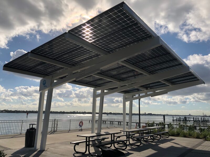 Solar Canopy Shade Structure provides shade for people at the picnic area in front of the water at the Manatee Viewing Center in Florida