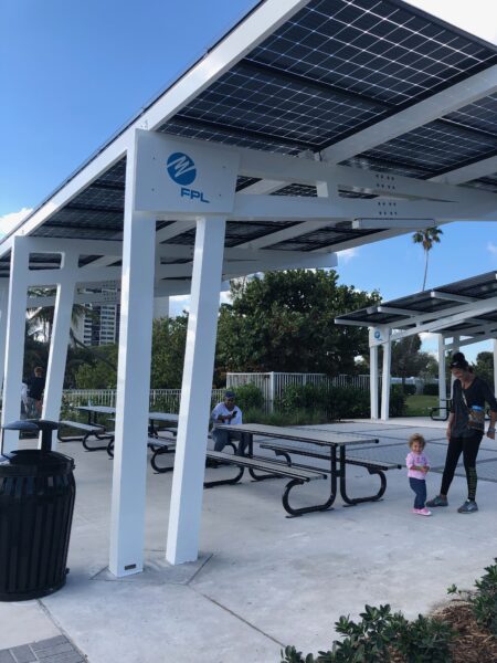 Solar Canopy Shade Structure covers the picnic area in front of the water at the Manatee Viewing Center in Florida