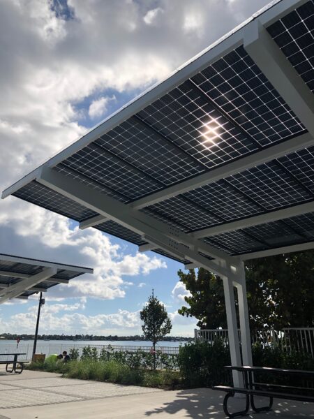 Solar Panel Canopy Shade Structure provides shade and solar power for people at the picnic area in front of the water at the Manatee Viewing Center in Florida
