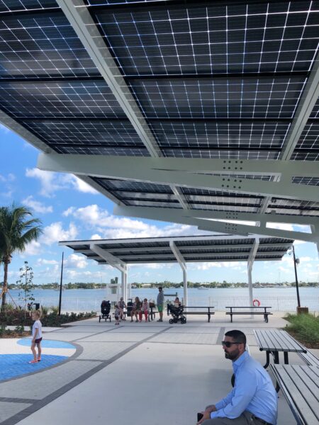 Solar Canopy Structure provides shade and solar power for people sitting on benches in front of the water at the Manatee Viewing Center in Florida