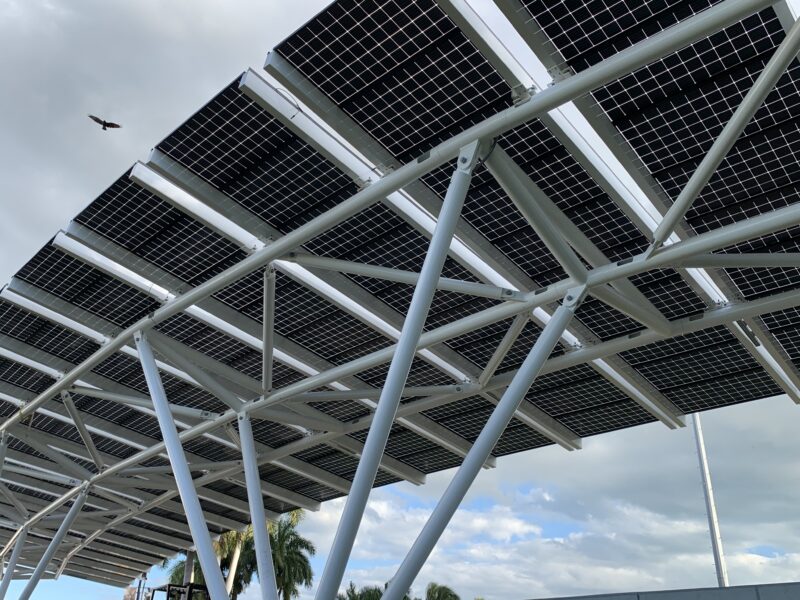 LSX Curved Solar Module System elevated above Miami Bayfront Park walkway with view of buildings in downtown Miami .