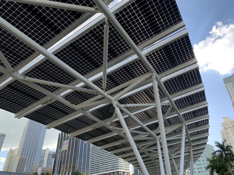 LSX Curved Elevated Solar Module System covers the walkway at Miami Bayfront Park with view of downtown Miami in background