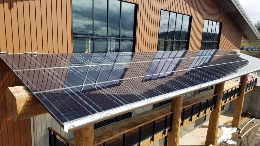 Frameless Solar Modules on awning covering walkway around building.
