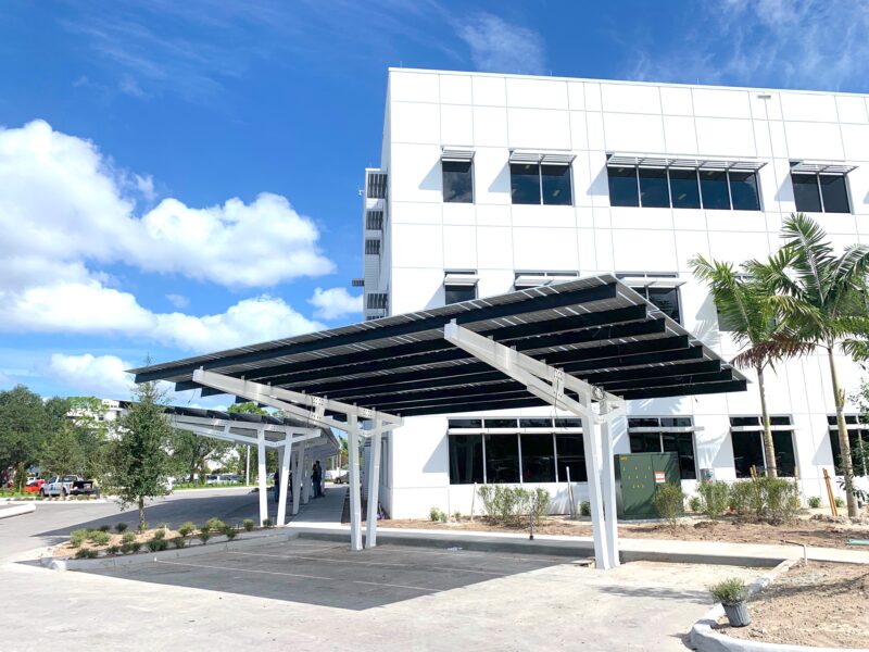 Solar Powered Parking Structure with shade canopy and LED Lighting in parking lot of office building in Florida.