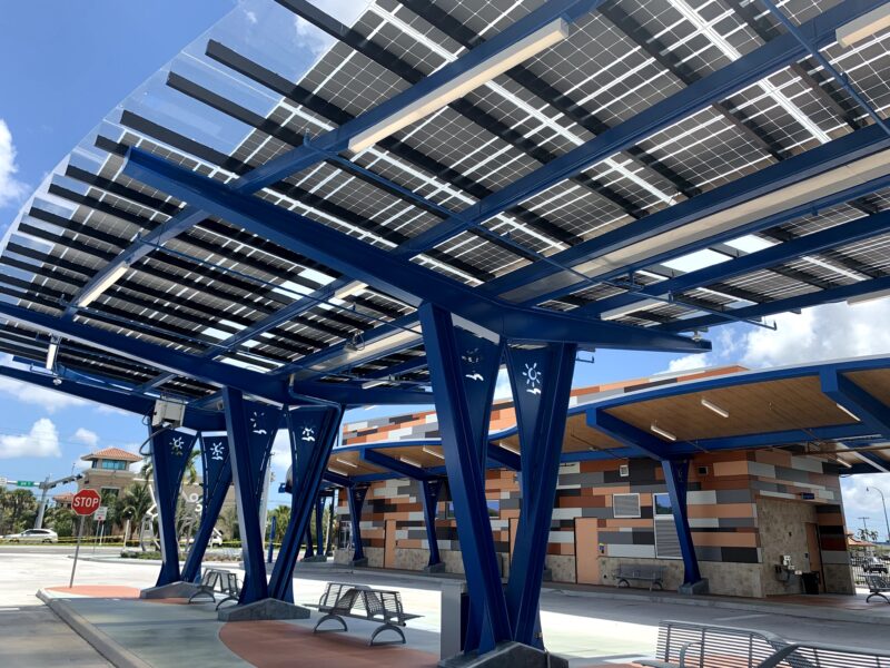 LSX Solar Canopy with curved design and custom blue framing spans the length of the platform at the West Lauderhill Mall Transit Center.