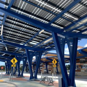 LSX Solar Canopy with curved design and custom blue framing spans the length of the bus platform at the West Lauderhill Mall Transit Center.