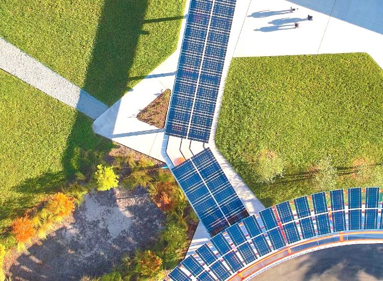 Aerial View of Custom LSX Solar Canopy Structure built over sidewalk and lawn with people walking nearby.