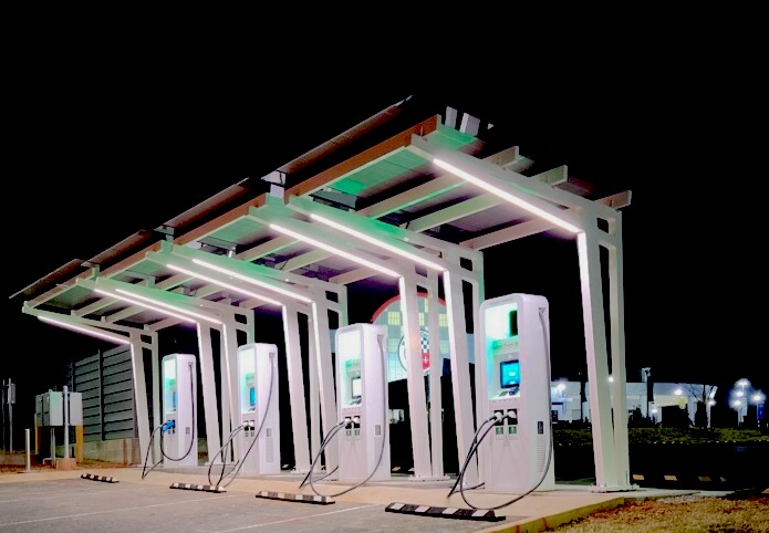 Night time view of multiple solar powered EV charging stations